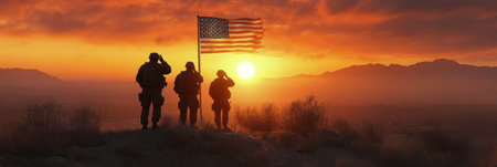 Three soldiers stand on a hillside, saluting while holding an American flag during a stunning sunset. The sky glows orange and pink, casting a beautiful backdrop against their silhouettes.の素材