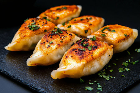 Three freshly prepared dumplings displayed with meticulous care, highlighting their smooth texture and shape. This culinary creation represents traditional cooking techniques and flavors.の素材