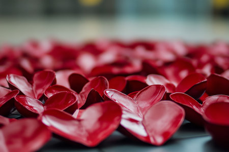 A multitude of vibrant red hearts are scattered across a smooth surface, creating a festive atmosphere ideal for celebrations or creative displays.の素材