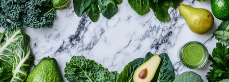 A variety of fresh greens, including kale, spinach, and avocado, are artistically arranged around a green smoothie on a marble surface, highlighting healthy eating.の素材