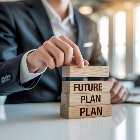 Businessman placing wooden block with future plan word on the table.の素材