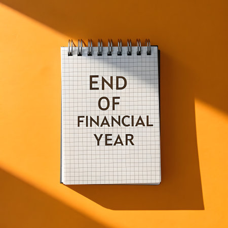 End of Financial Year text on notepad with shadow on orange backgroundの素材