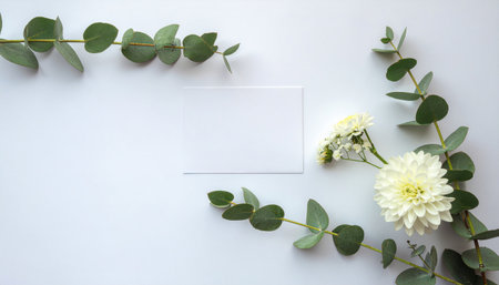 Creative layout made of flowers and leaves with paper card note flat lay on white background featuring natural floral elements and space for text, ideal for greeting cards, invitations, stationeryの素材