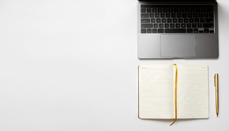 Laptop with pen and notebook flat lay on white background showcasing workspace essentials, ideal for office branding, productivity projects, remote work themes, and business presentations.の素材