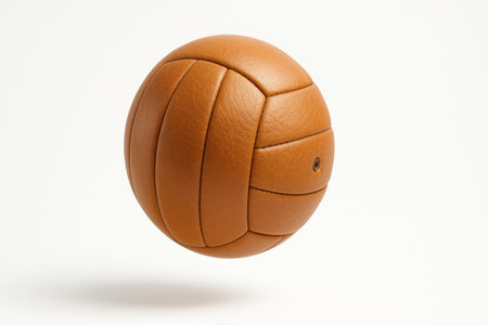 Leather volleyball captured midair against pure white clean sports equipment visual for fitness training and school athleticsの素材