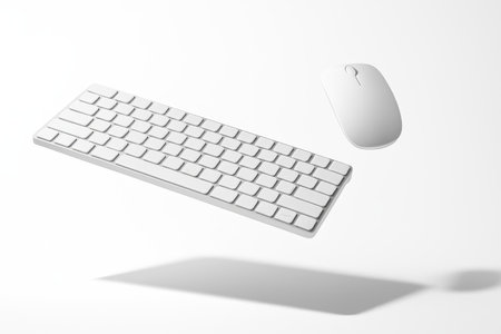 Computer keyboard and mouse levitating in a gentle diagonal on pure whiteの素材