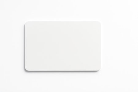 Top down view of single white gift card centered in frame on pure whiteの素材