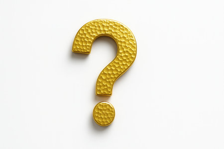 Hammered gold question mark laid flat top down on a light table bright metal texture studio on whiteの素材