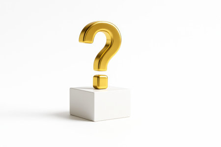 Polished bright gold question mark standing upright on a matte white acrylic block elegant symbol concept on whiteの素材