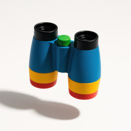 Unbranded plastic toy binoculars captured in gentle mid air with a faint shadow ellipse playful kids gear on whiteの素材