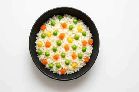 White rice with mixed vegetables served in a matte black bowl clean appetizing food studio isolated on pure whiteの素材