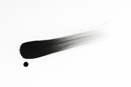 Black brush stroke with hand drawn ink spot on pure white long horizontal stroke fading from deep black to dry grainの素材
