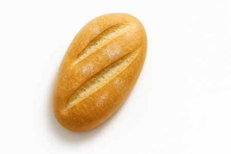 Traditional Turkish bread somun ekmek top down oval loaf with light diagonal scoring and a whisper of flour on whiteの素材