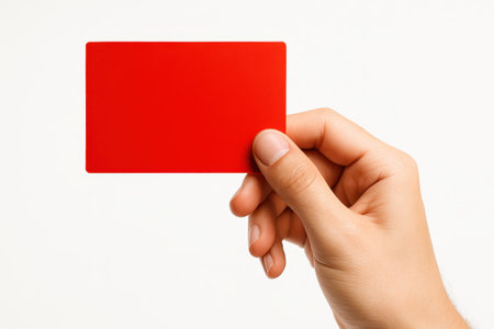 Human hand holding red card on white background three quarter front eye level view with card in landscape for branding design and identity themesの素材