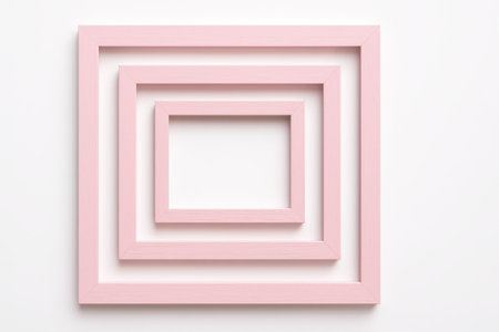 Pink wooden frames nested concentrically top down on white background for gallery wall mockup interior decor and graphic design themesの素材