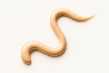 BB cream ribbon creating elegant s curve on white background with gel texture tiny bubbles and luminous sheen for skincare beauty and cosmetic themesの素材