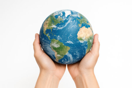 Blue planet earth resting in two cupped human hands on white background global environment care concept for climate awareness sustainability education and charity designの素材
