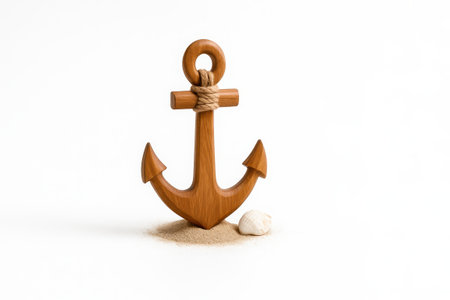 Wooden anchor with hemp rope standing upright on sand with seashell at base on pure white background nautical decor image for beach interior and marine brandingの素材