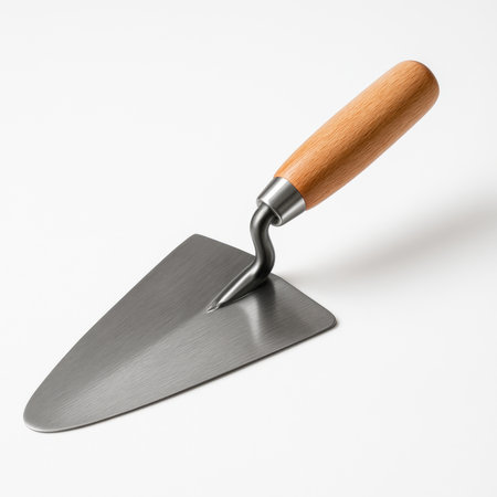 Clean steel construction trowel with wooden handle lying diagonally on pure white background with soft shadowの素材