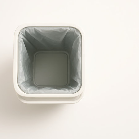 Top view plastic recycle bin with removable inner liner slightly pulled up on white background eco waste sorting hygiene and environmental sustainability conceptの素材