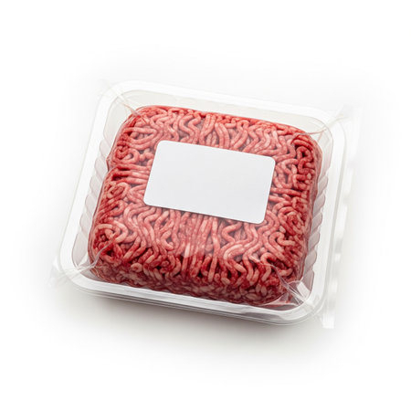 Minced meat in plastic box isolated on white background. Top view.の素材