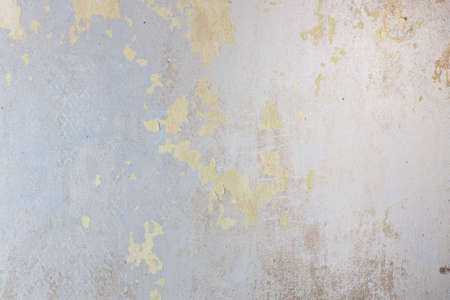 Photo of an unpainted wall with pieces of old paint, texture and patternsの写真素材