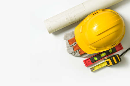Blueprint Yellow safety helmet for construction and tools on white background.の写真素材