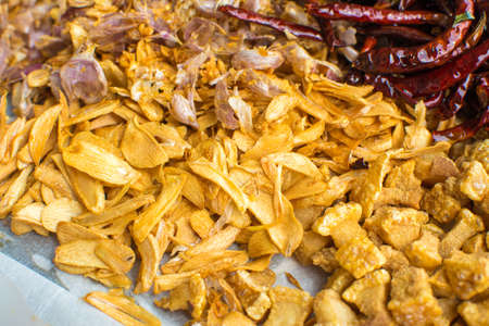Cooking components of Thai food. Chili, garlic, onion, kaffir lime leaves, pork crackling, fried.の写真素材