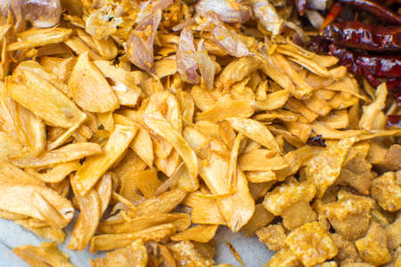 Cooking components of Thai food. Chili, garlic, onion, kaffir lime leaves, pork crackling, fried.の写真素材
