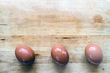 Three unpainted eggs lie on a wood table. Easter concept. Eco-friendly conceptの写真素材