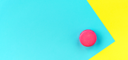 Pink macaroons on a yellow and blue background.の写真素材