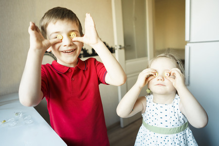 funny brother and sister close their eyes with candy like glassesの写真素材