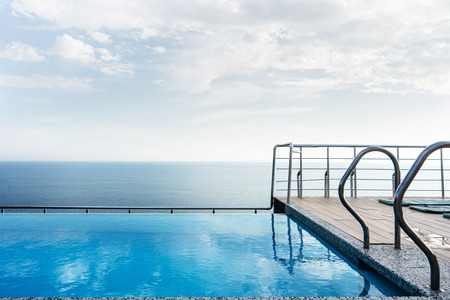 Pool on the roof of the house overlooking the sea. Luxury and leisure concept.の写真素材