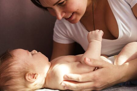 Beautiful closeup of mother and newborn baby on soft background. Happy spring day. Health care. Family, newborn. Happy childhood. Love card.の写真素材