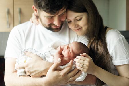 Father and mother with a newborn son. New multi-generation young family.