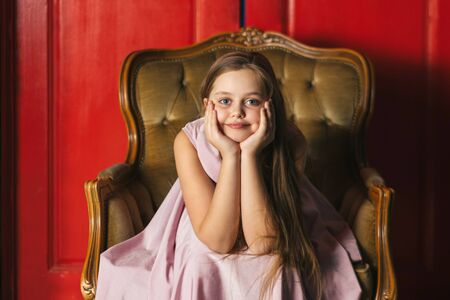 Beautiful young girl in pink dressの写真素材