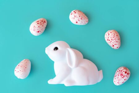 White toy neon rabbit with eggs candy on Neo mint background . Festive easter layout. Minimal Creative Idea Concept. Family holiday. Baby kids funの写真素材