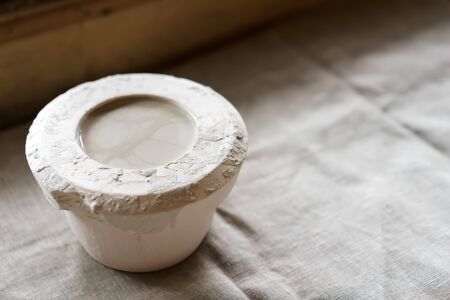 Mold for casting clay products with a mixture inside. Shaped method for making clay dishes. Handwork. Pottery makingの写真素材