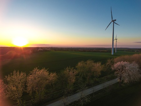 Eco power wind turbines at sunset evening