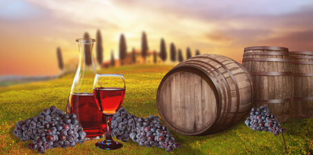 Red wine barrel against Tuscan landscape Italyの写真素材