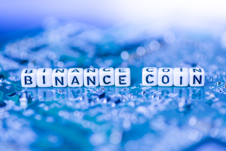 Word BINANCE COIN formed by alphabet blocks on mother cryptocurrencyの写真素材