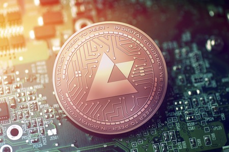 shiny copper AUCTUS cryptocurrency coin on blurry motherboard backgroundの写真素材