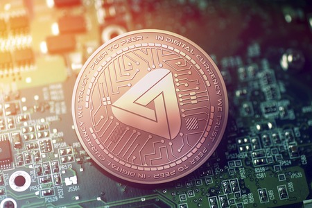 shiny copper MAIDSAFECOIN cryptocurrency coin on blurry motherboard backgroundの写真素材