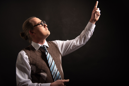 Funny nerd or geek pointing with finger to empty spaceの写真素材