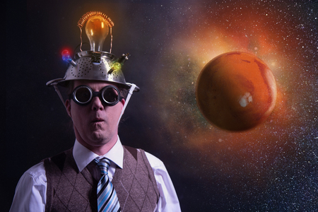 Funny scientist looking to universe and planet marsの写真素材