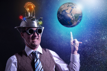 Funny scientist looking to universe and planet earthの写真素材