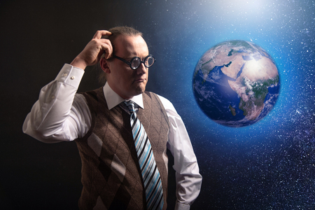 Funny scientist looking to universe and planet earthの写真素材
