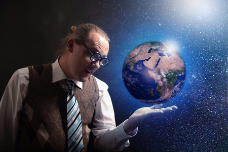Funny scientist looking to universe and planet earthの写真素材