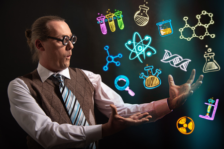 Funny scientist looking to chemistry symbols chemicalの写真素材
