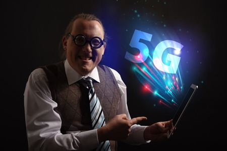 Funny nerd or geek wiith tablet and 5G symbolの写真素材